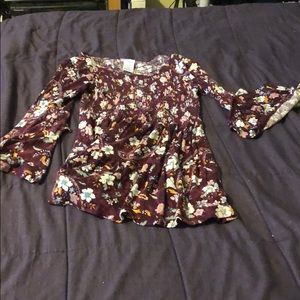 A blouse with the red and flowers all over